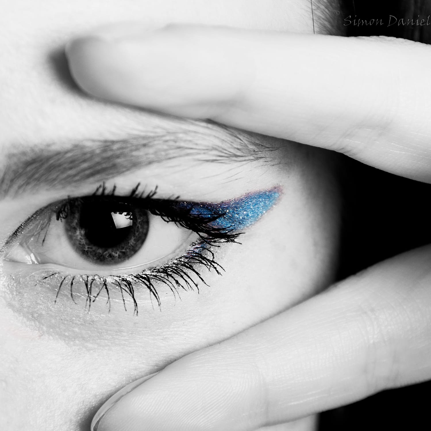 Close-up of eye showing Latisse eyelashes and blue eyeshadow