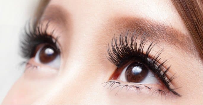 Close up of Asian eyes with dark, long Latisse lashes