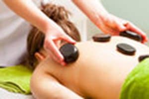Hot Stones applied to a woman's back for a Hot Stone Massage