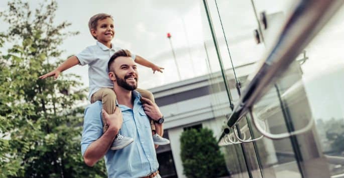 Father with son on his shoulders remains healthy and active