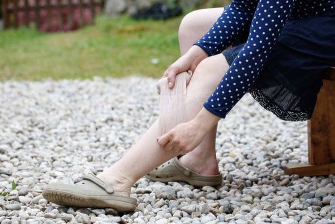 Woman's legs wearing Crocs wrapping legs for better blood circulation